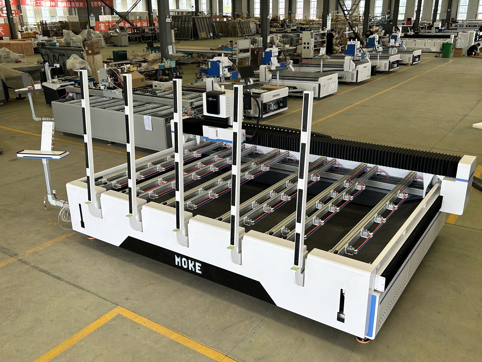 CF1530 with its pneumatic loading arms raised beside the open-grid worktable
